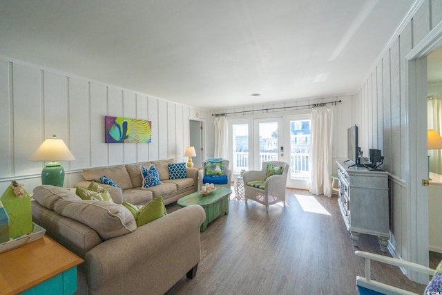 living area with wood finished floors and a decorative wall