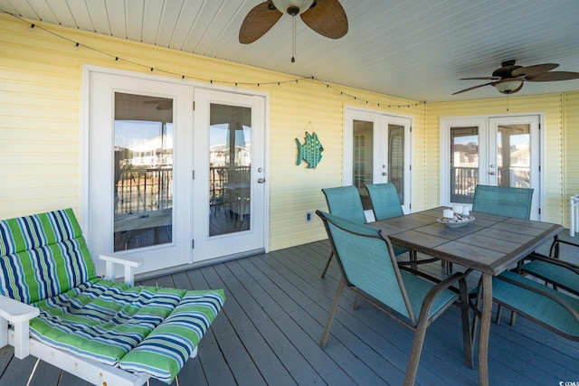 wooden deck with ceiling fan, french doors, and outdoor dining area