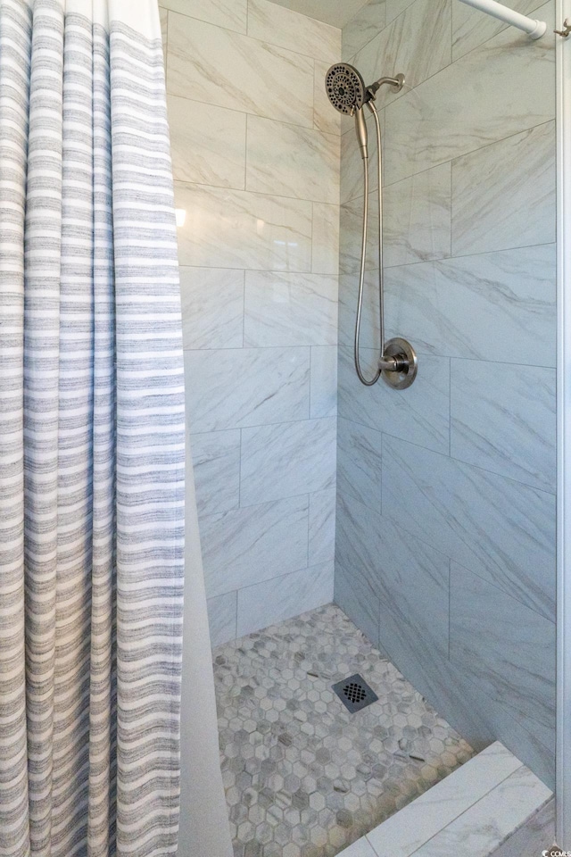 full bath with a tile shower