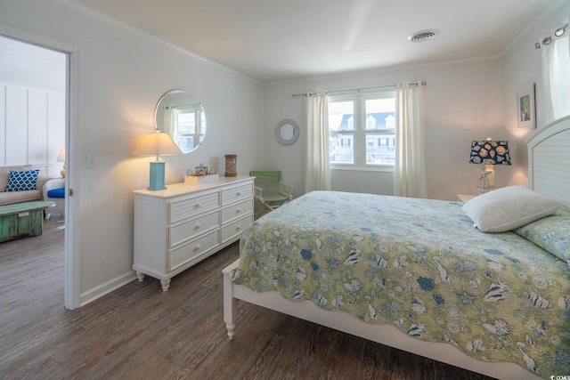 bedroom with ornamental molding, dark wood-style flooring, visible vents, and multiple windows