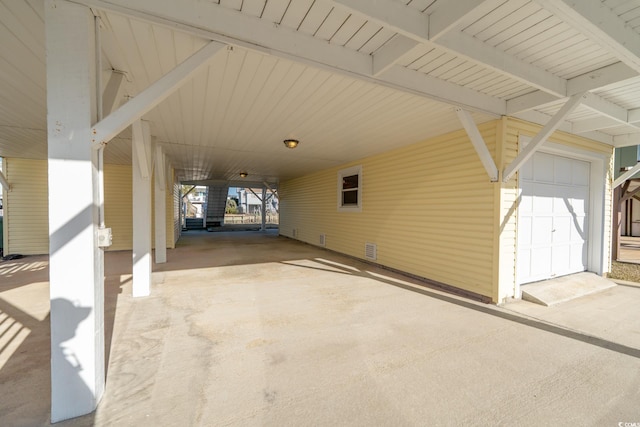 view of patio / terrace featuring a carport and concrete driveway