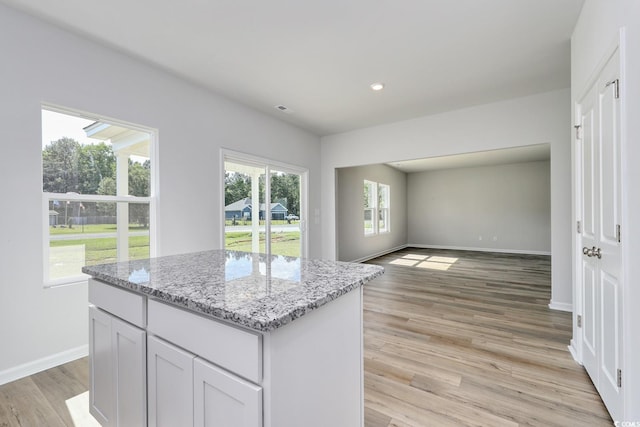 491 Wagner Cir, Conway, SC 29526 - kitchen with baseboards, light stone counters, a center island, light wood-style floors, and recessed lighting