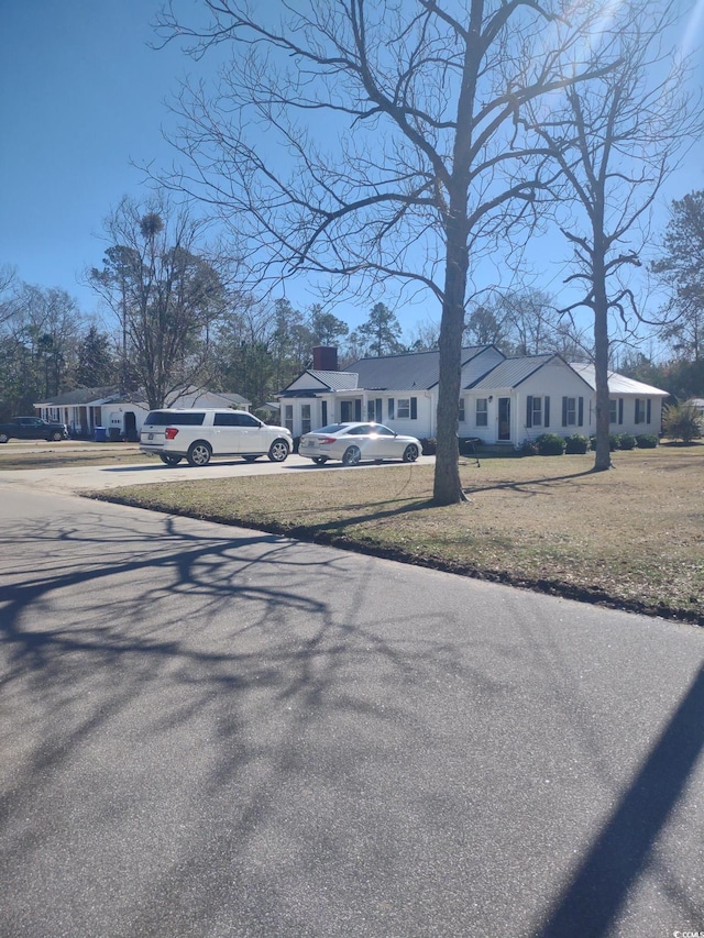 exterior space with driveway, a residential view, and a front yard