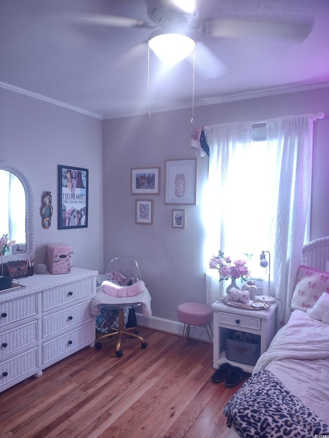 bedroom with ornamental molding, ceiling fan, baseboards, and wood finished floors