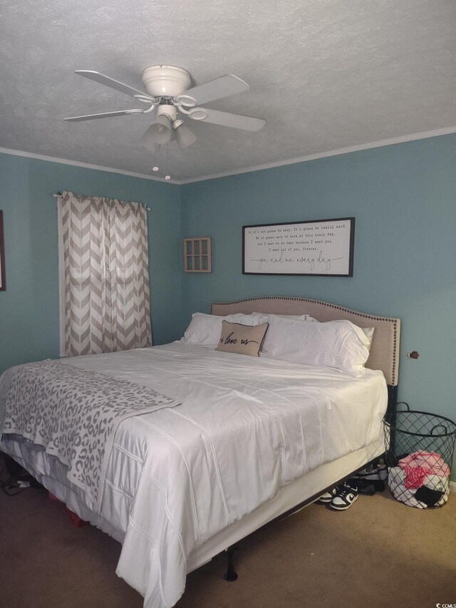 bedroom featuring carpet, crown molding, a textured ceiling, and ceiling fan