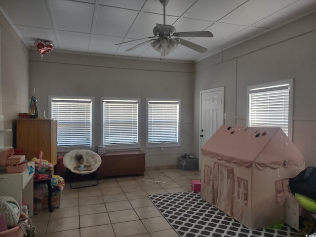 interior space with a ceiling fan and light tile patterned floors