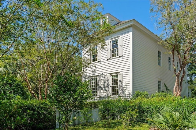 view of side of property featuring fence