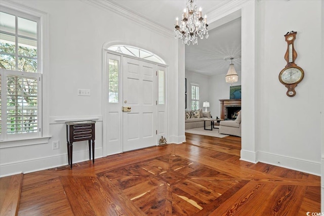 foyer featuring a healthy amount of sunlight, baseboards, a fireplace, and ornamental molding