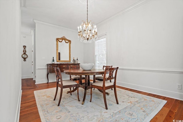 dining room with baseboards, a chandelier, wood finished floors, and crown molding