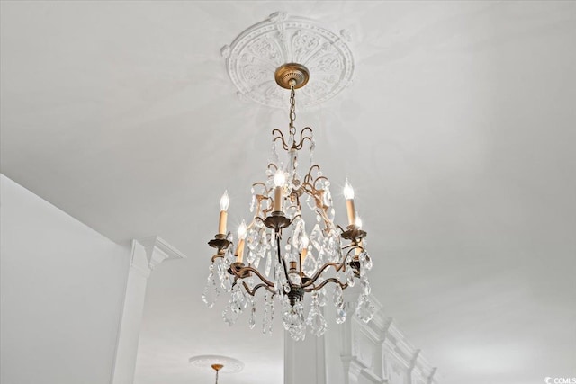 interior details featuring an inviting chandelier