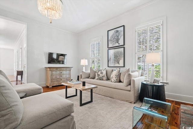 living room featuring baseboards, ornamental molding, and wood finished floors