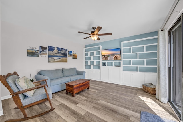 living area with light wood finished floors and ceiling fan