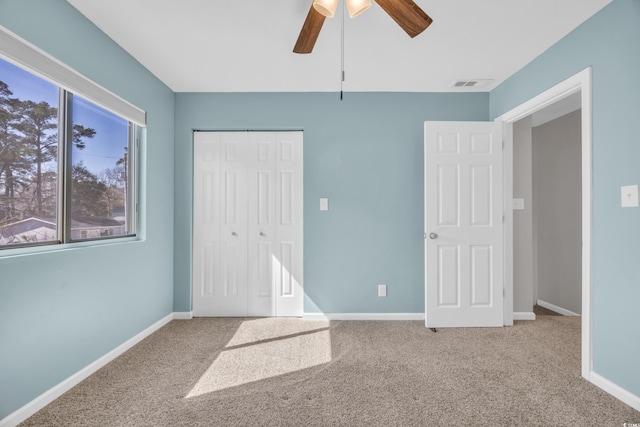 unfurnished bedroom with a closet, baseboards, and carpet