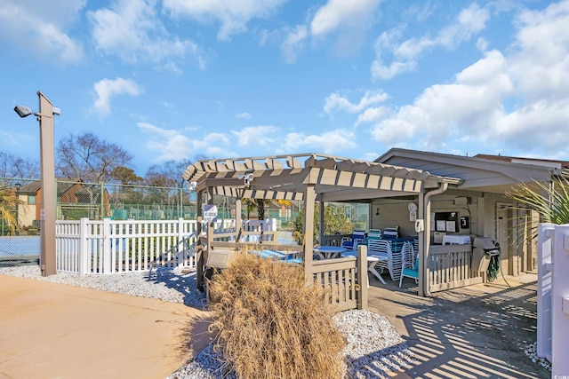 view of property's community featuring fence and a pergola