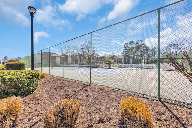 view of sport court with fence