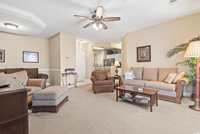 living area featuring baseboards, visible vents, ceiling fan, a textured ceiling, and carpet flooring