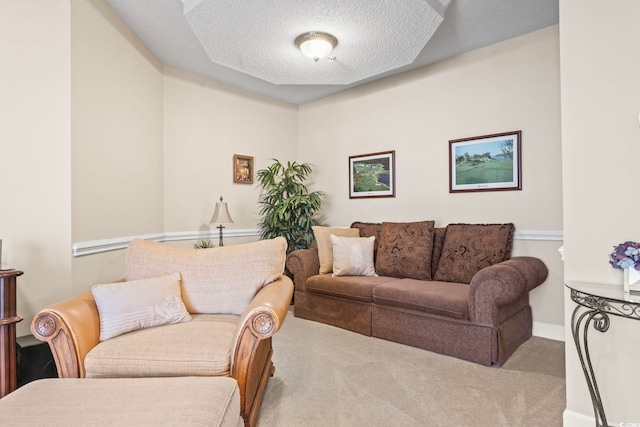 carpeted living room featuring a textured ceiling