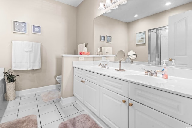 full bathroom with double vanity, a stall shower, tile patterned flooring, and a sink