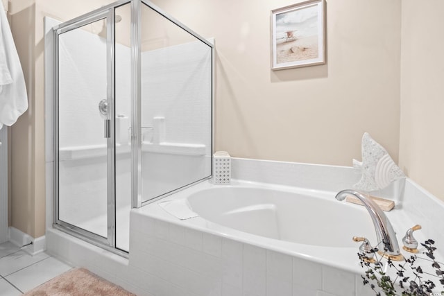 full bath featuring a garden tub, a shower stall, and tile patterned floors