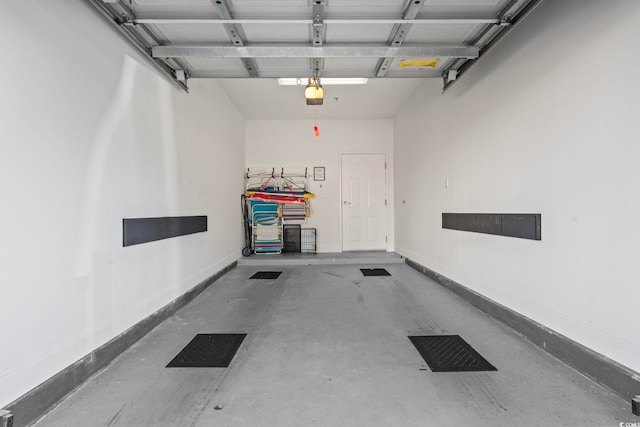 garage with a garage door opener and baseboards