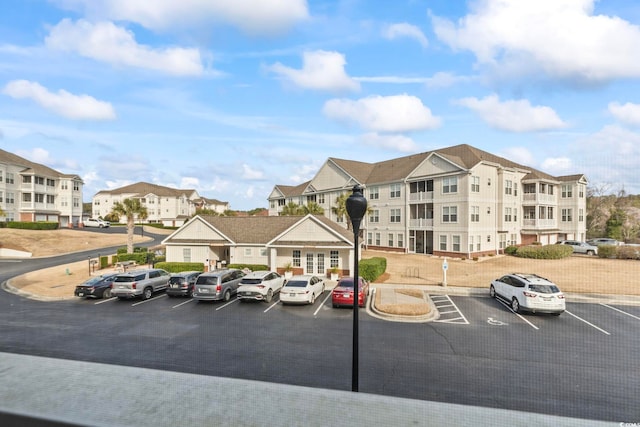 uncovered parking lot featuring a residential view