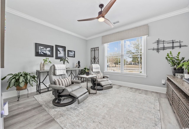 living area featuring visible vents, wood finished floors, and ornamental molding