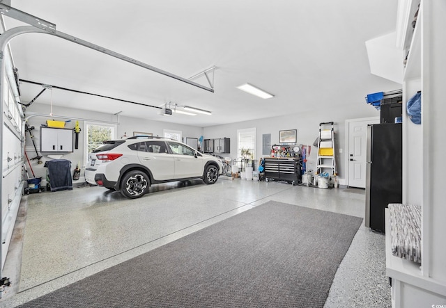 garage with freestanding refrigerator and a garage door opener