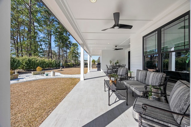 view of patio / terrace featuring a ceiling fan, outdoor dining space, and an outdoor hangout area