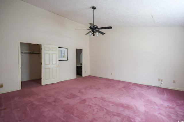 unfurnished bedroom featuring high vaulted ceiling, a closet, carpet, and a ceiling fan