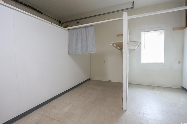 spare room with light floors and baseboards