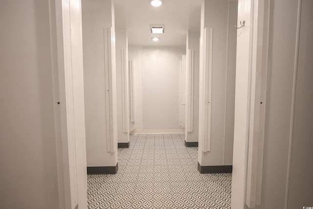 hallway with recessed lighting and baseboards