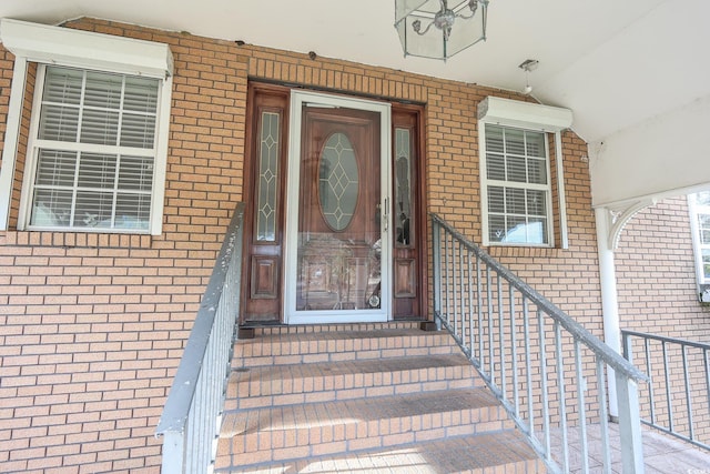 property entrance with brick siding