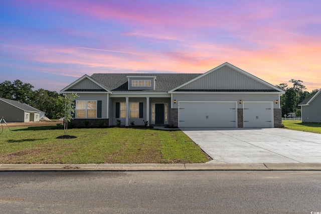 view of front of home featuring concrete driveway, brick siding, a lawn, and an attached garage