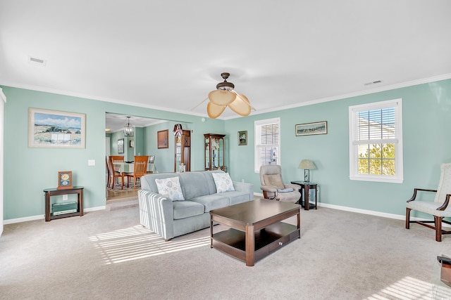 carpeted living room featuring visible vents, crown molding, and baseboards