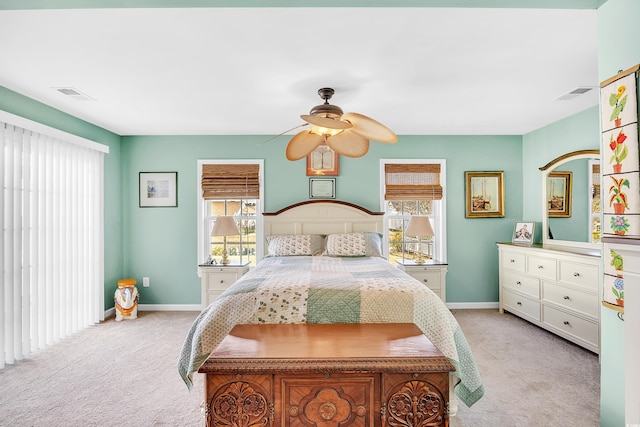 bedroom with light carpet, multiple windows, and visible vents