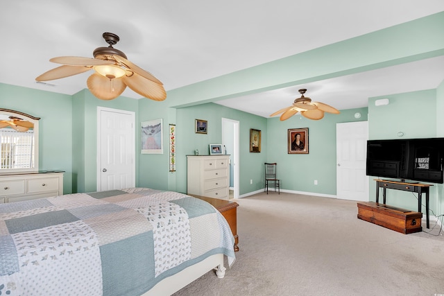 carpeted bedroom with ceiling fan and baseboards