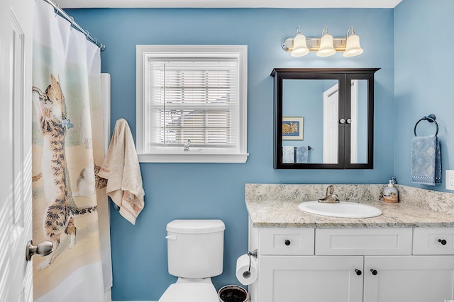 full bath featuring toilet, a shower with curtain, and vanity