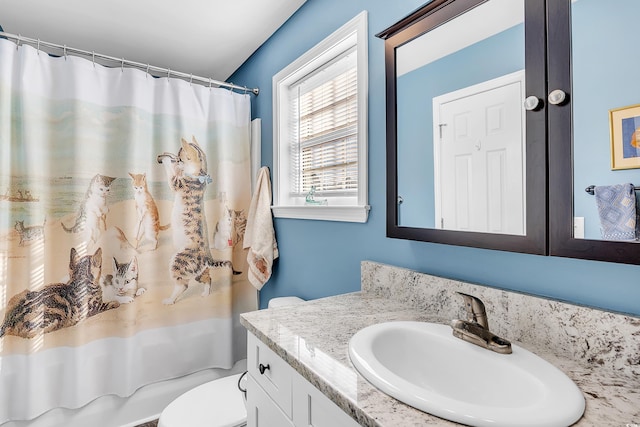 bathroom with toilet, shower / bath combo with shower curtain, and vanity