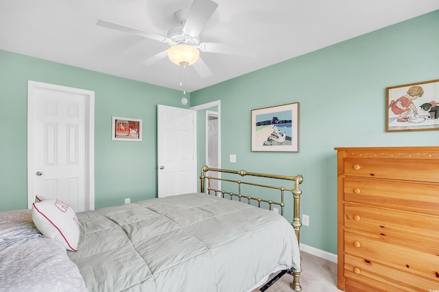 carpeted bedroom featuring a ceiling fan and baseboards