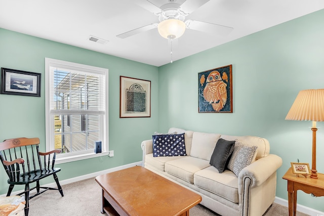 living area with carpet, visible vents, baseboards, and a ceiling fan