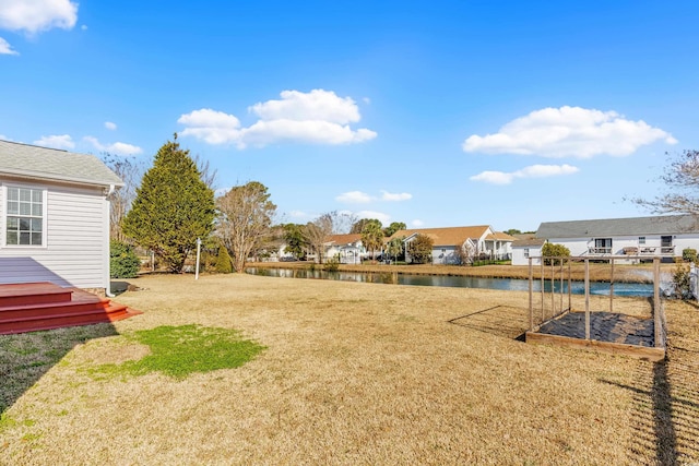 view of yard with a water view and a residential view