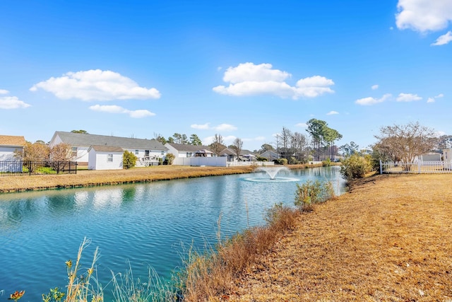 property view of water featuring a residential view and fence