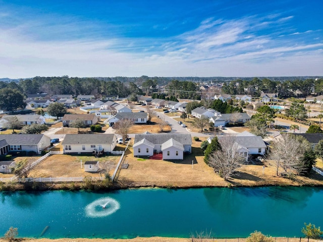 birds eye view of property with a water view and a residential view