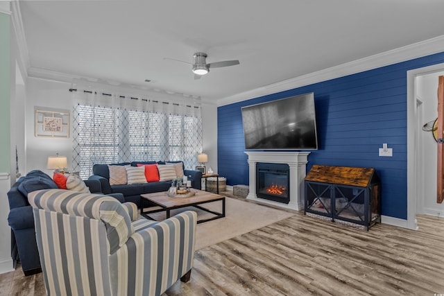 1118 Prescott Cir, Myrtle Beach, SC 29577 - living room featuring crown molding, ceiling fan, wood finished floors, baseboards, and a glass covered fireplace