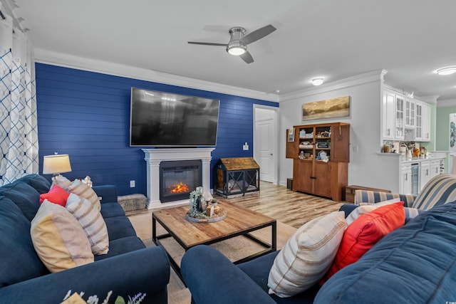 1118 Prescott Cir, Myrtle Beach, SC 29577 - living room with crown molding, a ceiling fan, wine cooler, a glass covered fireplace, and light wood-type flooring