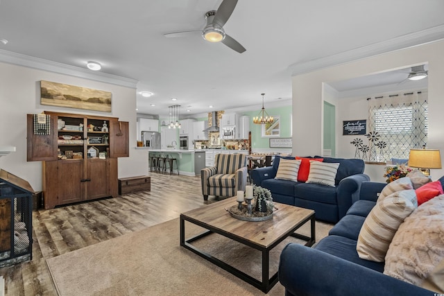 1118 Prescott Cir, Myrtle Beach, SC 29577 - living room featuring crown molding, a ceiling fan, a chandelier, wood finished floors, and recessed lighting