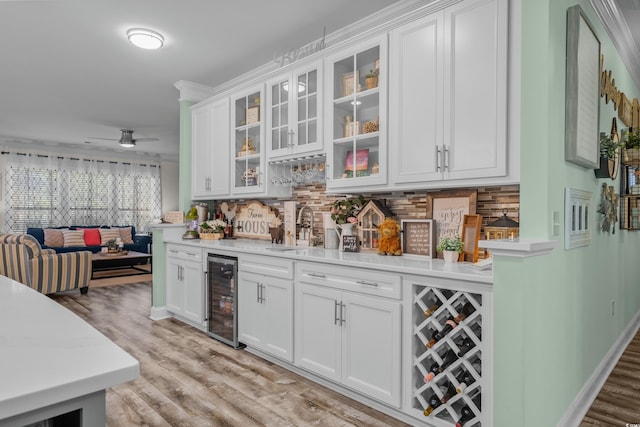 1118 Prescott Cir, Myrtle Beach, SC 29577 - indoor wet bar featuring beverage cooler, tasteful backsplash, light wood-style floors, and a ceiling fan