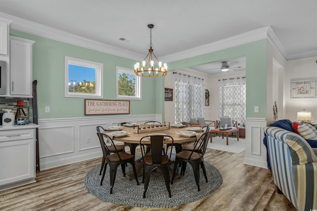 1118 Prescott Cir, Myrtle Beach, SC 29577 - dining room with light wood finished floors, ornamental molding, wainscoting, ceiling fan, and a decorative wall