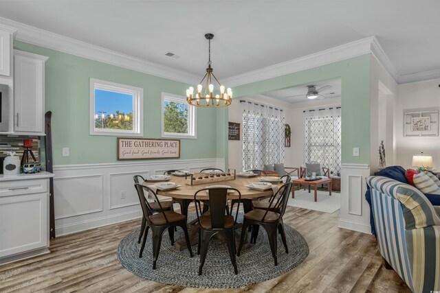 1118 Prescott Cir, Myrtle Beach, SC 29577 - dining room with light wood finished floors, ornamental molding, wainscoting, ceiling fan, and a decorative wall