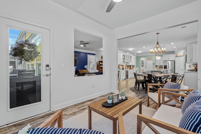 1118 Prescott Cir, Myrtle Beach, SC 29577 - living area with ceiling fan, crown molding, light wood-style floors, a chandelier, and baseboards